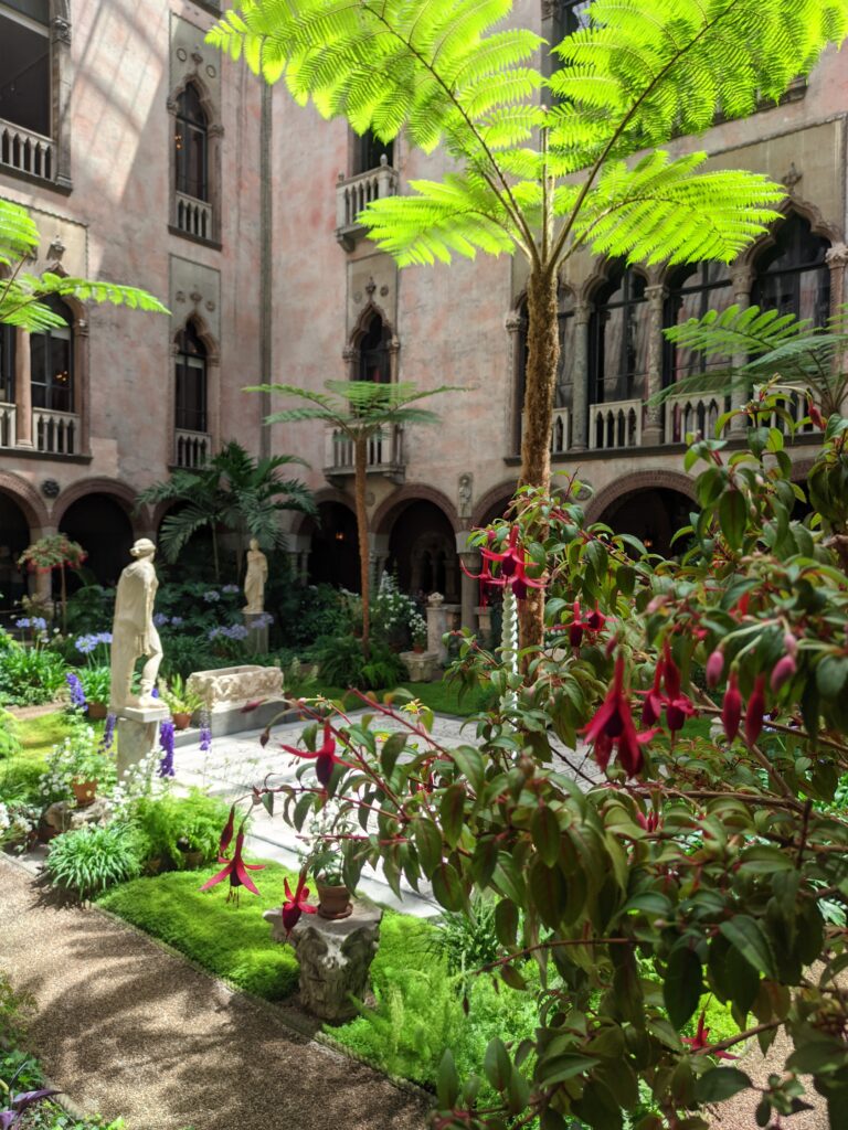 Gardner Museum Boston, garden inside with red flowers and statues